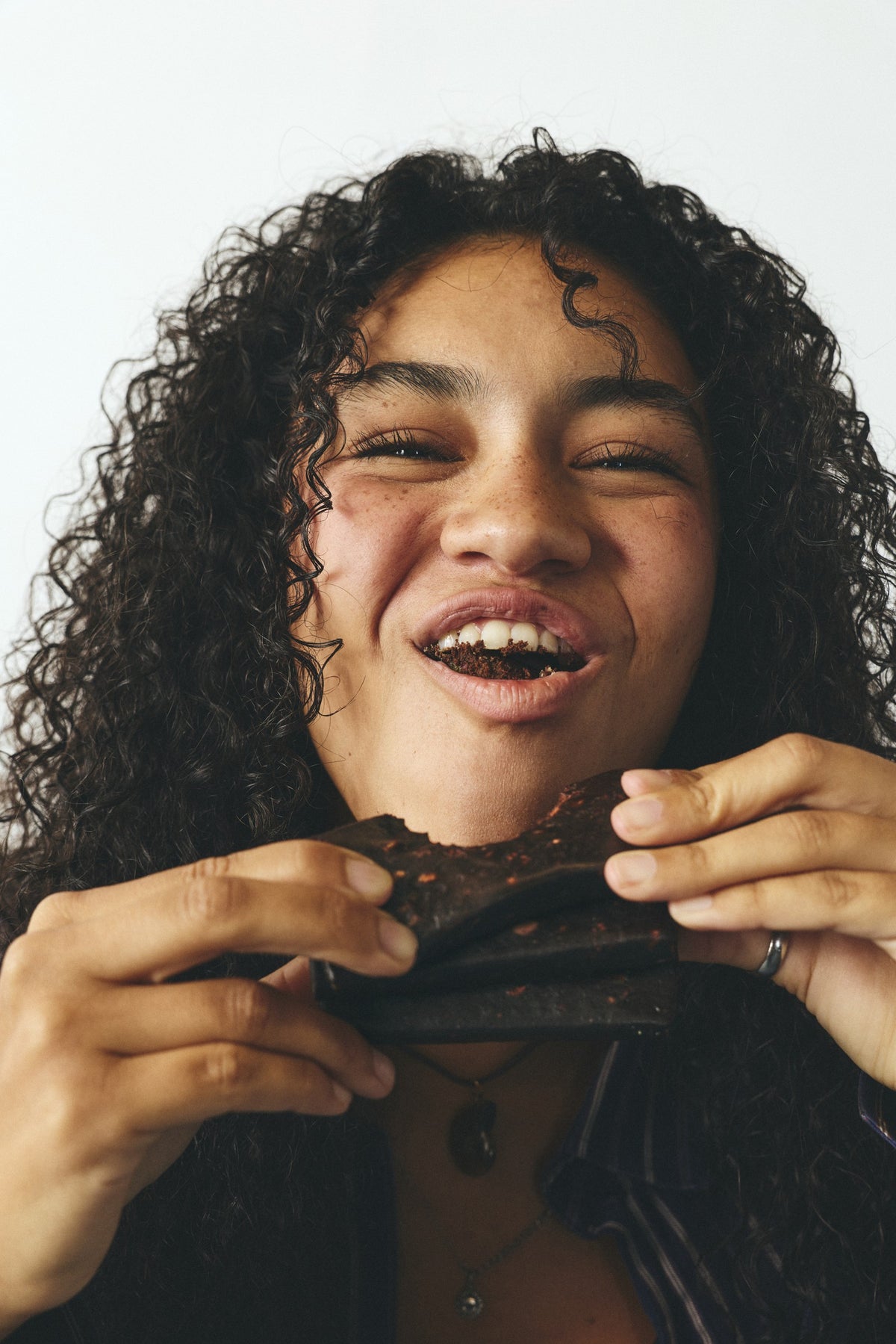 Malia laughing with an unwrapped Unhinged bar