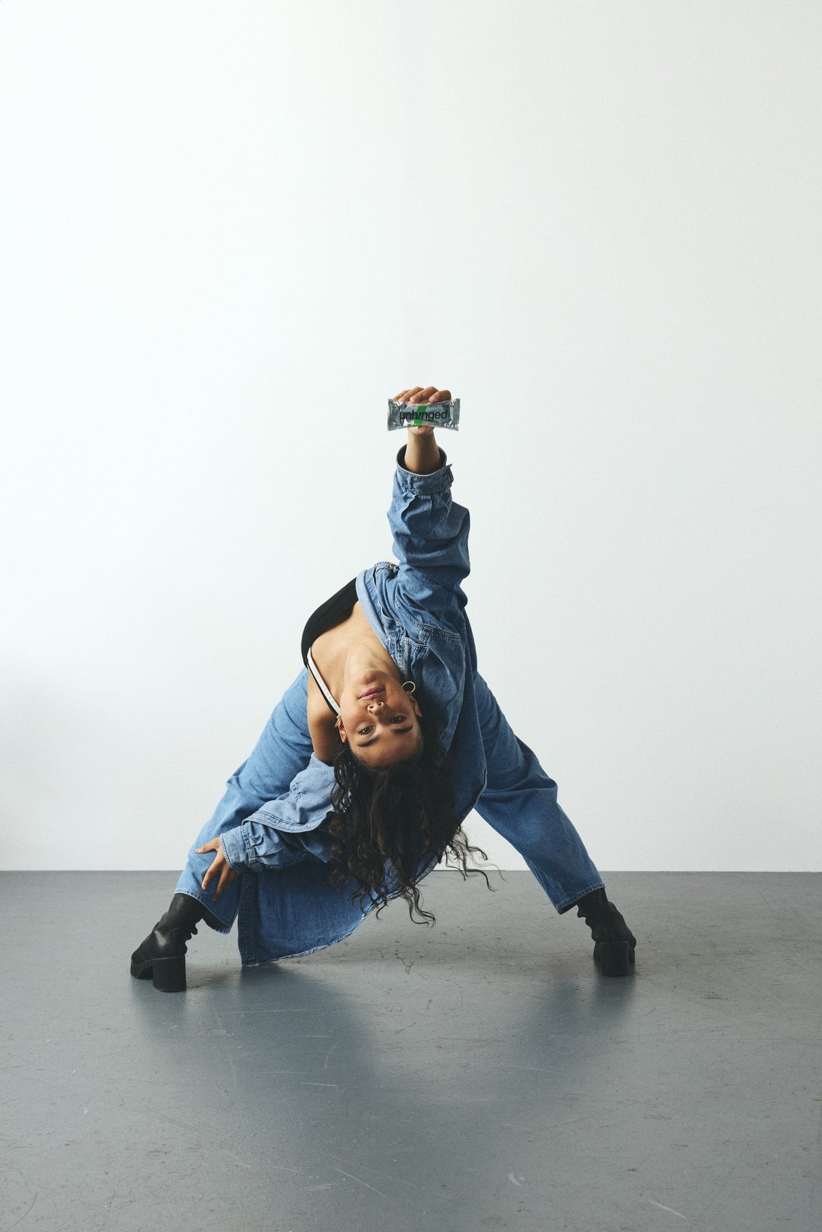 Mikayla bending backward while holding an Unhinged bar overhead